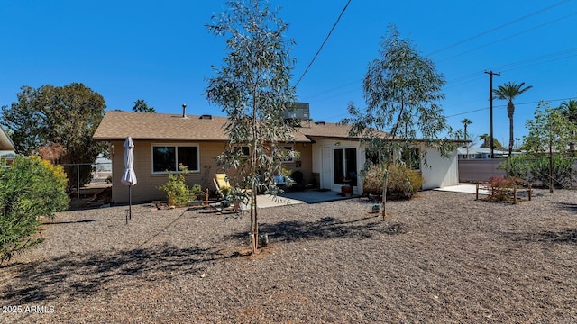 rear view of property with fence and a patio