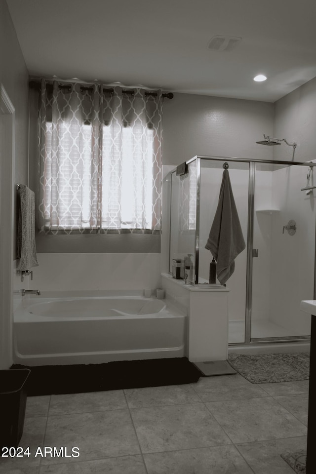 bathroom featuring tile patterned floors and independent shower and bath