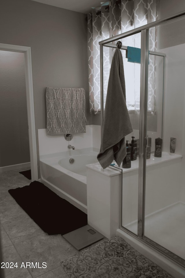 bathroom with tile patterned floors and plus walk in shower