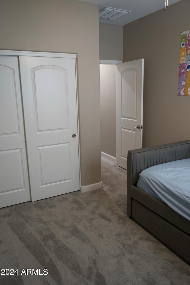 carpeted bedroom with a closet