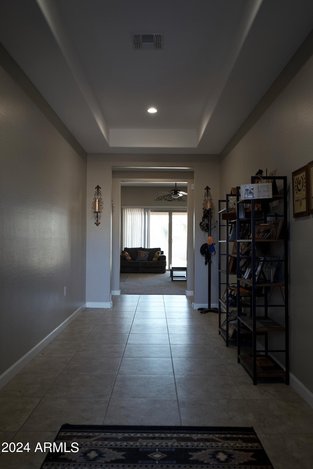 hall with a raised ceiling