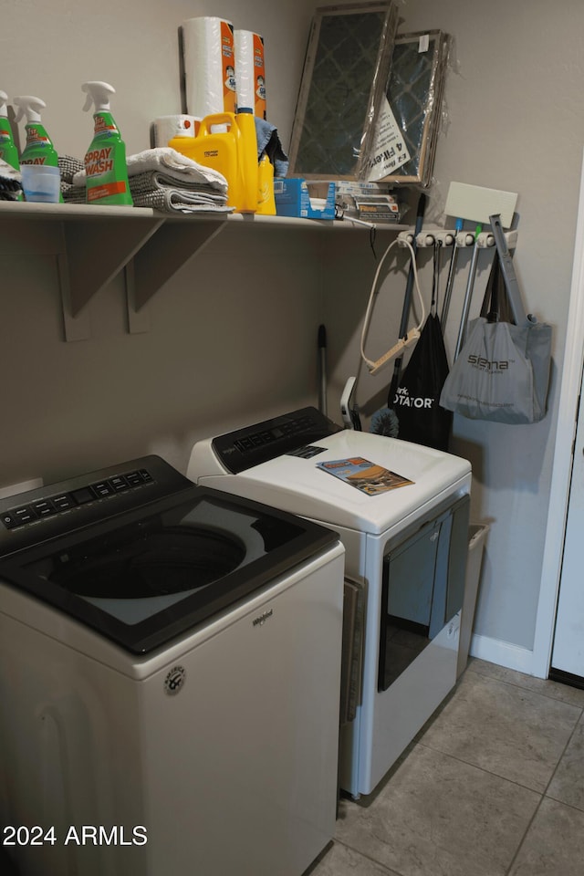 laundry room with light tile patterned floors and washing machine and clothes dryer