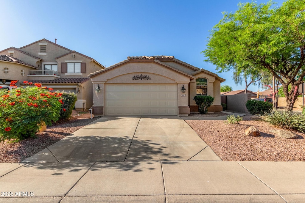 80 W Grey Stone St, San Tan Valley, AZ 85143 - view of front of property featuring concrete driveway, an attached garage, stucco siding, and a tiled roof