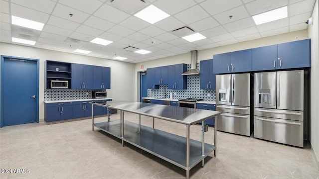 11890 E Cliffrose Ln, Florence, AZ 85132 - kitchen with stainless steel appliances, blue cabinets, open shelves, wall chimney range hood, and a paneled ceiling