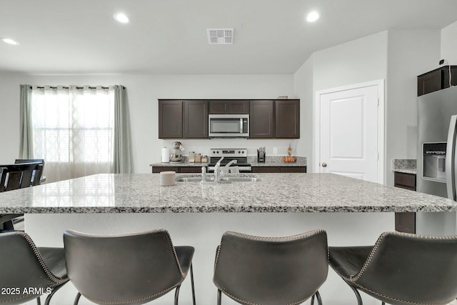 kitchen with a sink, stainless steel appliances, visible vents, and recessed lighting