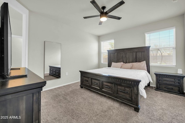 carpeted bedroom featuring baseboards and ceiling fan