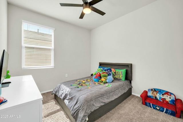 carpeted bedroom featuring baseboards and a ceiling fan