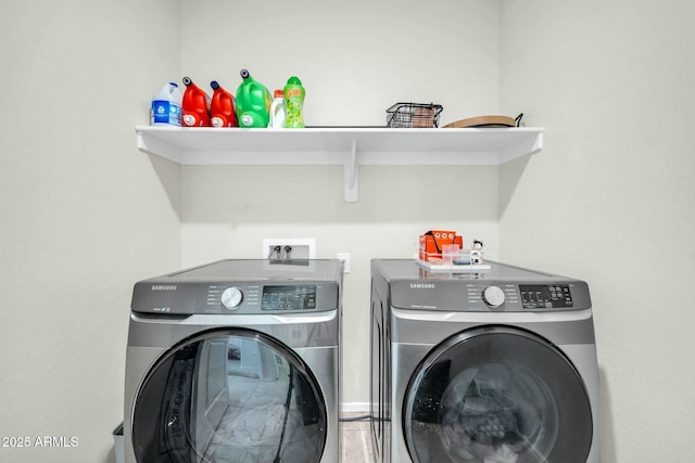 clothes washing area with laundry area and washer and clothes dryer