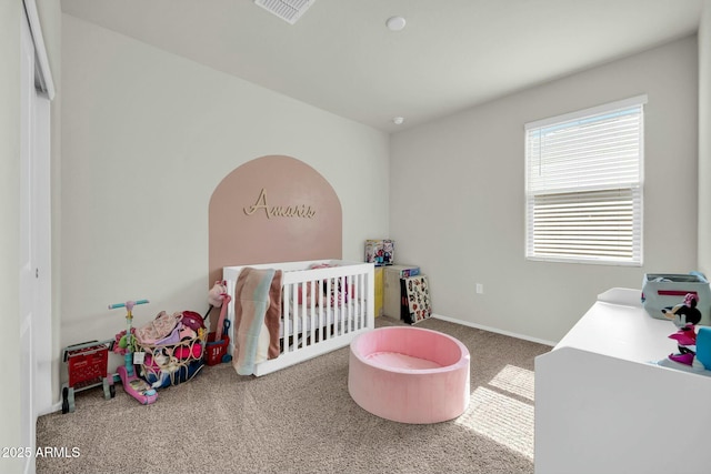 carpeted bedroom with visible vents and baseboards