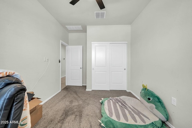 bedroom with baseboards, visible vents, carpet floors, and a closet