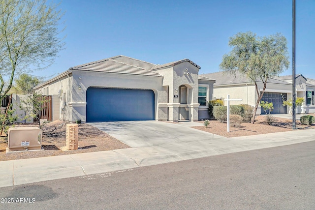 mediterranean / spanish-style house with fence, driveway, stucco siding, a garage, and a tiled roof