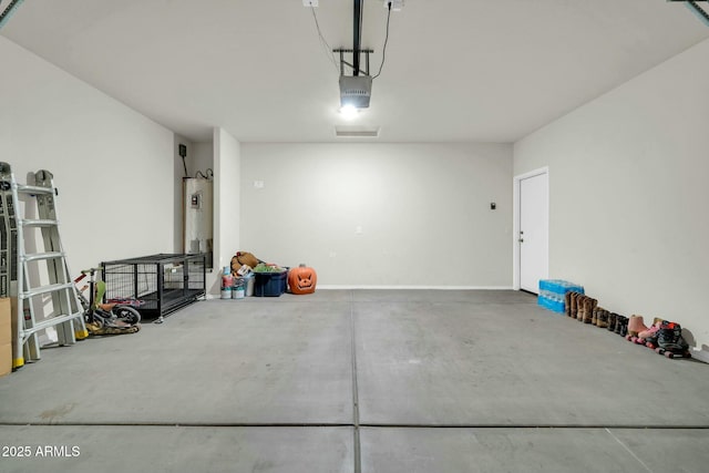 garage featuring a garage door opener and water heater