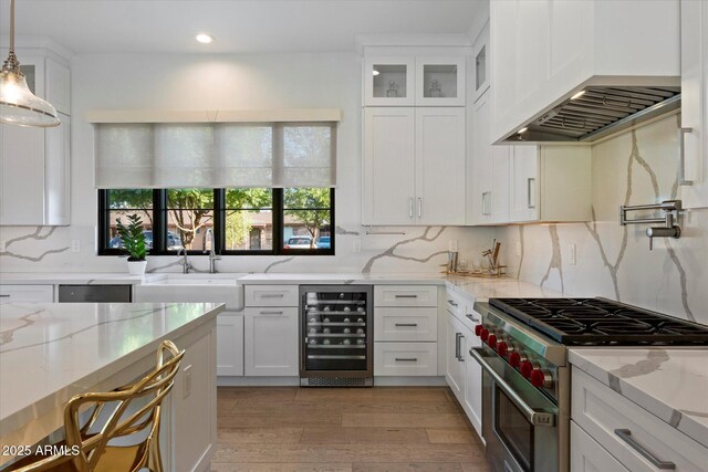 3808 E Fairmount Ave, Phoenix, AZ 85018 - kitchen with high end stainless steel range, wine cooler, custom range hood, white cabinets, and decorative backsplash