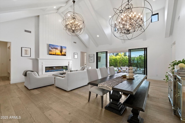 3808 E Fairmount Ave, Phoenix, AZ 85018 - dining area with high vaulted ceiling, a chandelier, beam ceiling, light wood-style floors, and a glass covered fireplace