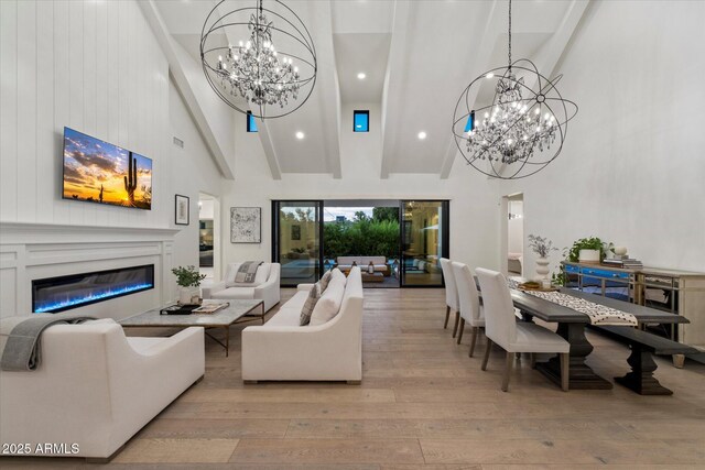 3808 E Fairmount Ave, Phoenix, AZ 85018 - living area with a chandelier, high vaulted ceiling, hardwood / wood-style flooring, a glass covered fireplace, and beam ceiling