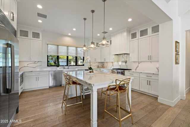 3808 E Fairmount Ave, Phoenix, AZ 85018 - kitchen featuring appliances with stainless steel finishes, white cabinets, light wood-style flooring, and recessed lighting
