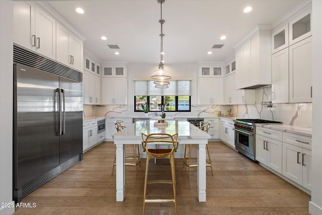 3808 E Fairmount Ave, Phoenix, AZ 85018 - kitchen with built in appliances, white cabinetry, recessed lighting, backsplash, and light wood-style floors
