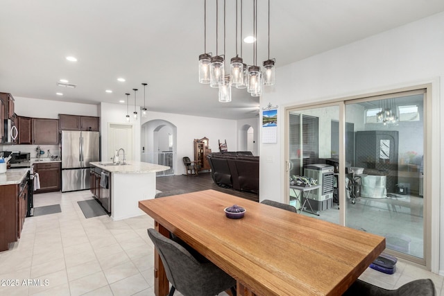 dining room with light tile patterned flooring and sink