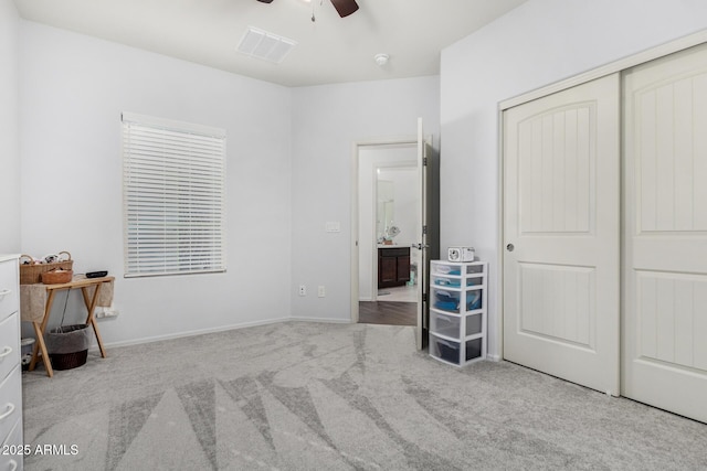 unfurnished bedroom with light carpet, a closet, and ceiling fan