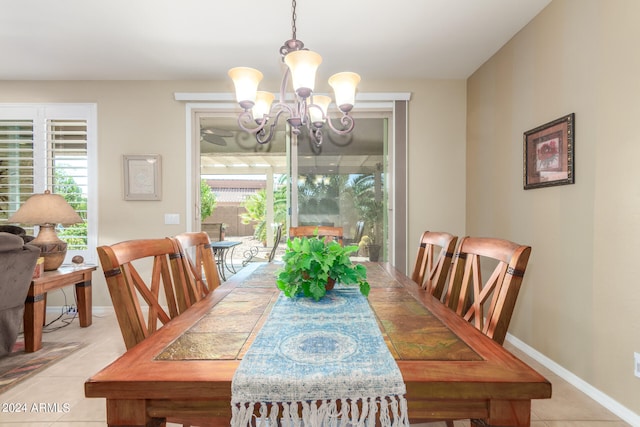 dining space featuring a wealth of natural light, a chandelier, and light tile patterned flooring