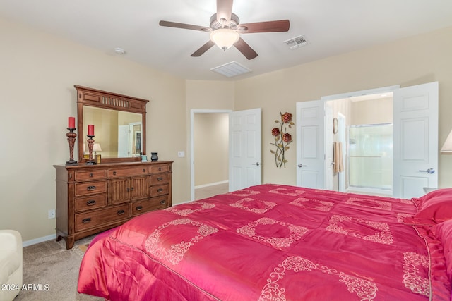 carpeted bedroom with ceiling fan and ensuite bath