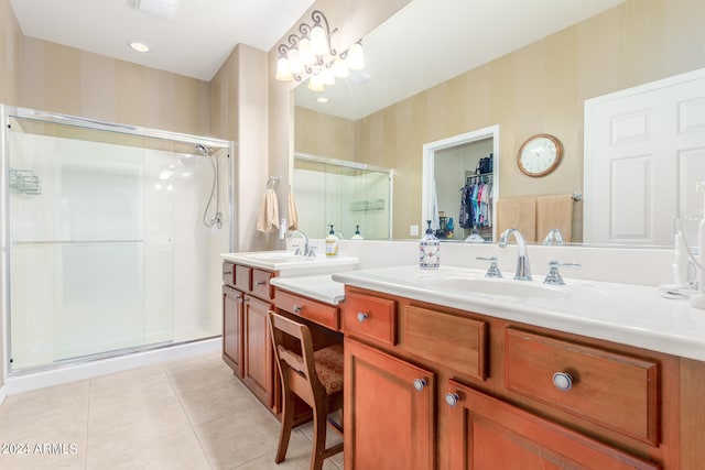 bathroom featuring vanity, an enclosed shower, and tile patterned flooring