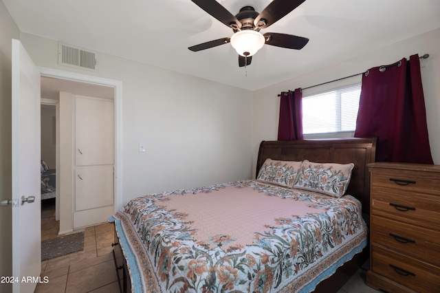 tiled bedroom with ceiling fan