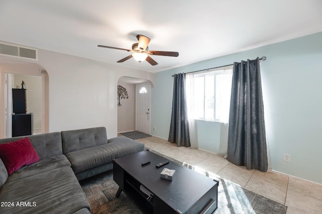 living room with ceiling fan and light tile patterned floors