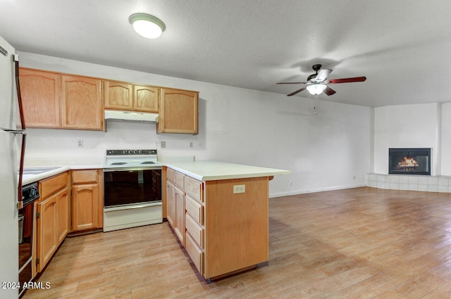 kitchen with a textured ceiling, ceiling fan, white range with electric stovetop, light hardwood / wood-style flooring, and kitchen peninsula