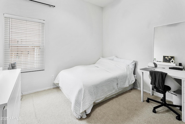 bedroom with baseboards and carpet