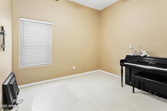 sitting room with baseboards and carpet floors