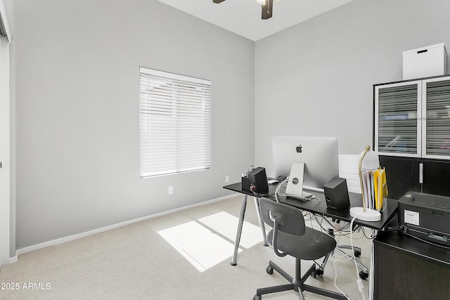 office space featuring carpet flooring, ceiling fan, and baseboards