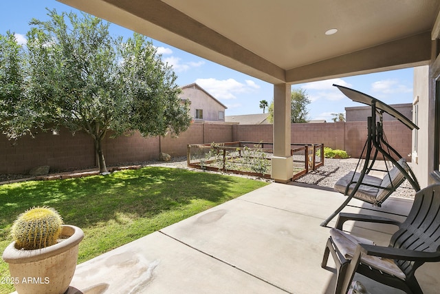 view of yard with a garden, a patio, and a fenced backyard