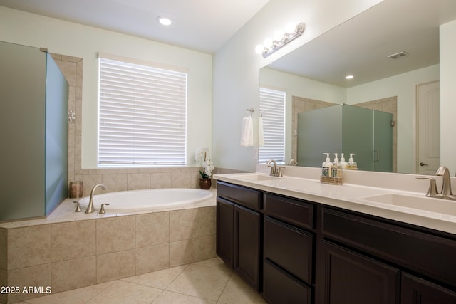 bathroom with tile patterned flooring, vanity, and shower with separate bathtub