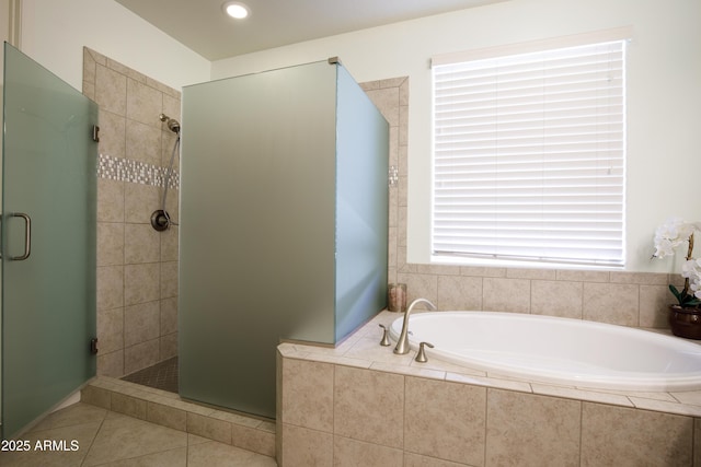 bathroom with tile patterned flooring and shower with separate bathtub