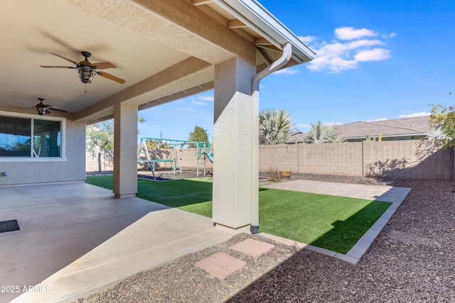 view of patio featuring ceiling fan and a playground