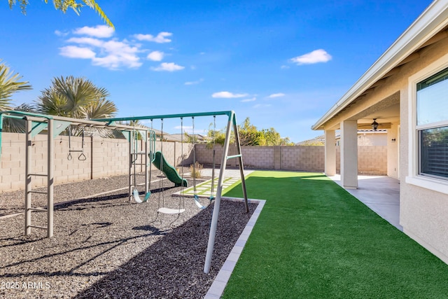 view of jungle gym with a patio and a lawn