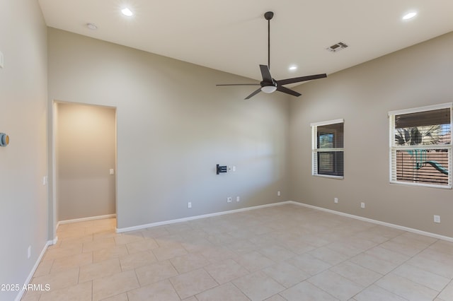 tiled empty room featuring ceiling fan