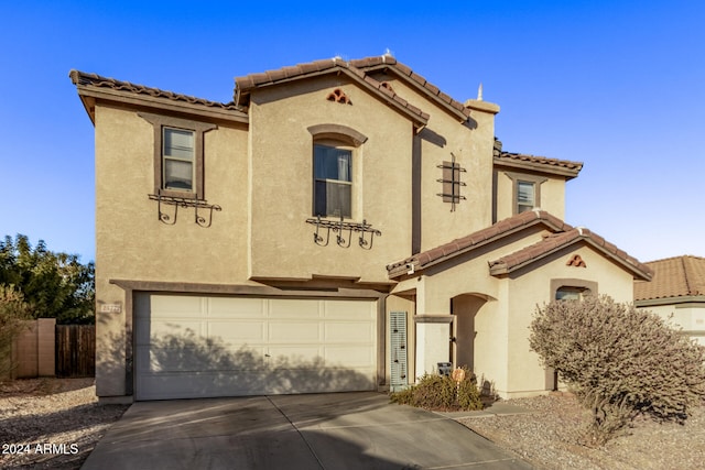 mediterranean / spanish-style home featuring a garage