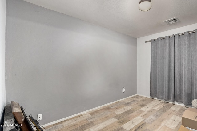 empty room with hardwood / wood-style flooring