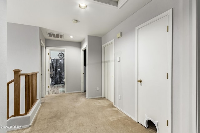 hallway featuring light carpet