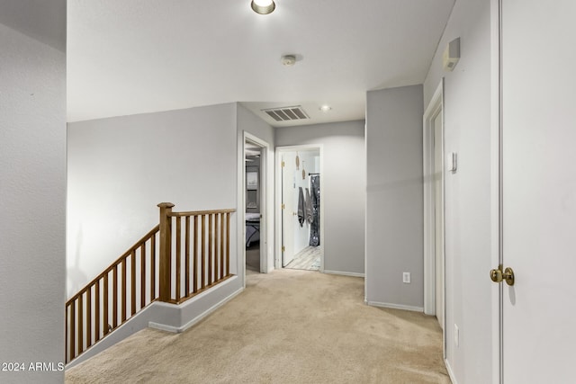 hallway with light colored carpet