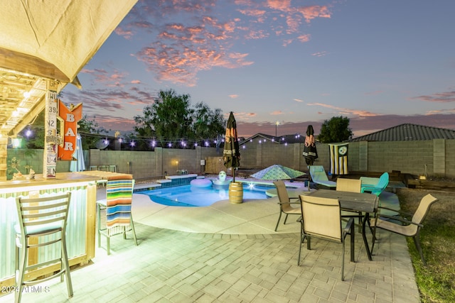 view of pool at dusk