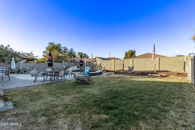 view of yard featuring a fire pit and a patio area