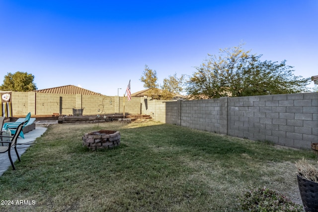 view of yard with an outdoor fire pit