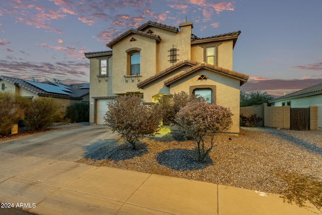 mediterranean / spanish-style home with a garage