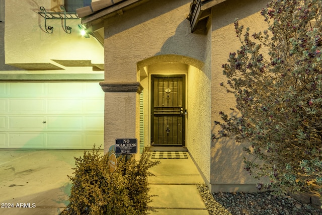 view of exterior entry with a garage