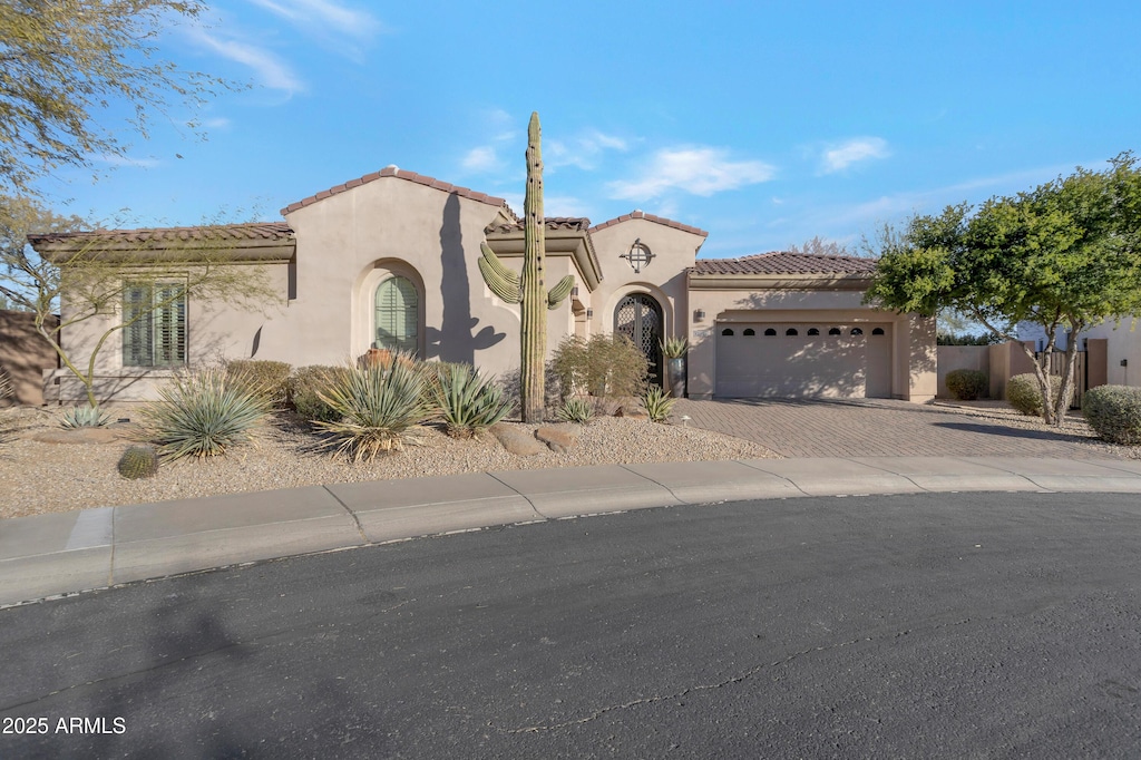 mediterranean / spanish-style house featuring a garage