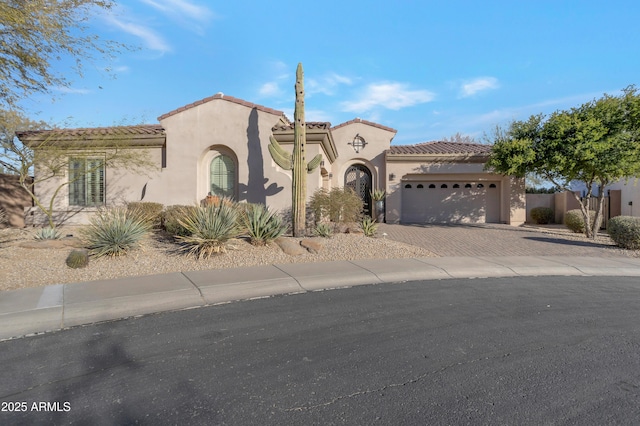 mediterranean / spanish-style house featuring a garage