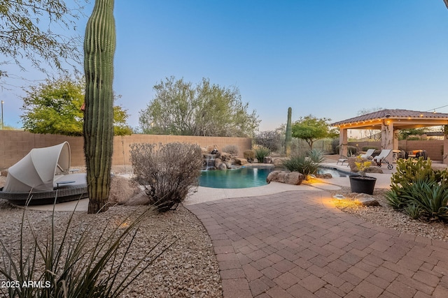 view of swimming pool with pool water feature, a gazebo, and a patio area